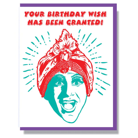 A rectangular greeting card with a letterpress image of Jambi from Pee Week’s Playhouse in red and green with the message “your birthday wish has been granted!” in red text 