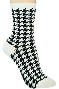 cotton knit socks in a classic black & white houndstooth pattern with ribbed white cuffs and toes.