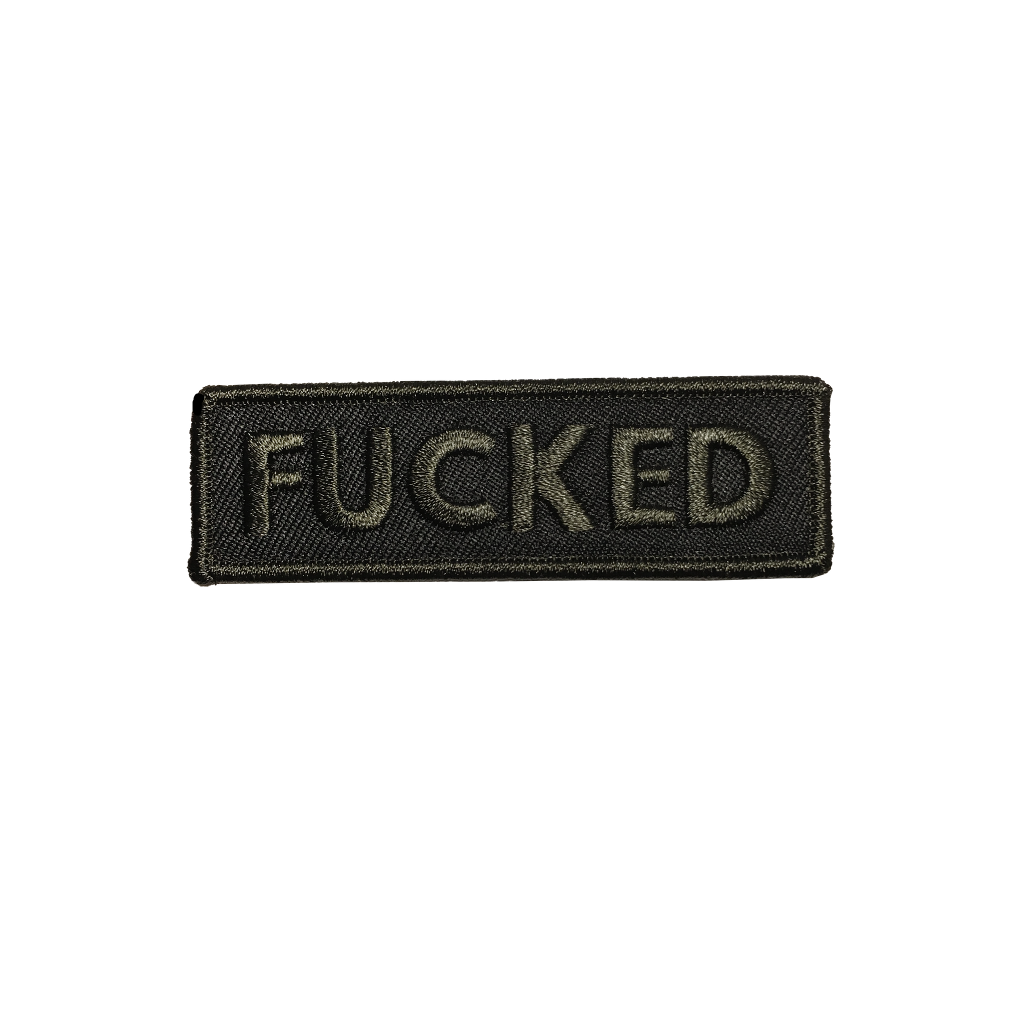 A rectangular embroidered patch with a black background and brownish black border with the word “FUCKED” in capital letters in that same brownish black 