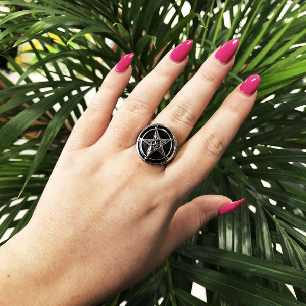 solid stainless steel signet-style ring featuring 7/8" round Baphomet symbol with black background, shown worn by model