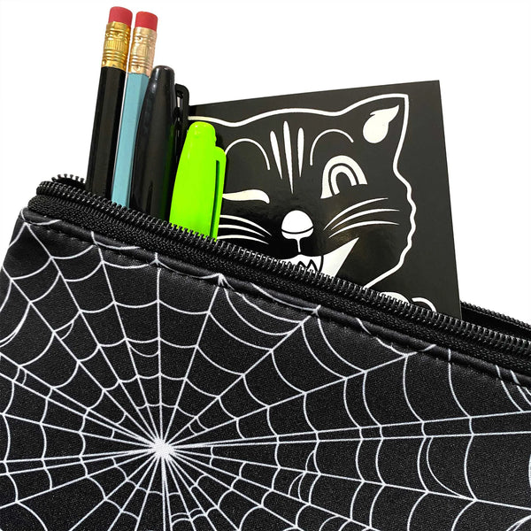 A black neoprene zippered pouch that is printed on both sides with a white spiderweb pattern. A shot showing the detail of the neoprene fabric and the spiderweb pattern