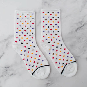 cotton knit socks in white with an allover red, orange, purple, brown, and black mini polka dot knit-in pattern