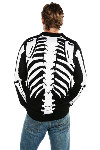 A jacquard knit sweater of a skeleton’s bones with a classic bony skeleton design in bright white on a black background. Sweater has ribbed collar, cuffs, and bottom hem in solid black. Shown from back on model