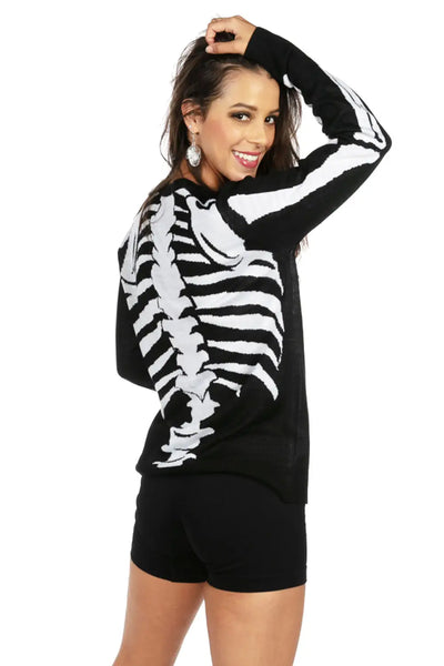 A long sleeved black round neck sweater with a jacquard knit pattern of a skeleton’s bones. Shown on model from behind 