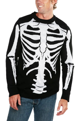 A jacquard knit sweater of a skeleton’s bones with a classic bony skeleton design in bright white on a black background. Sweater has ribbed collar, cuffs, and bottom hem in solid black. Shown from front on model