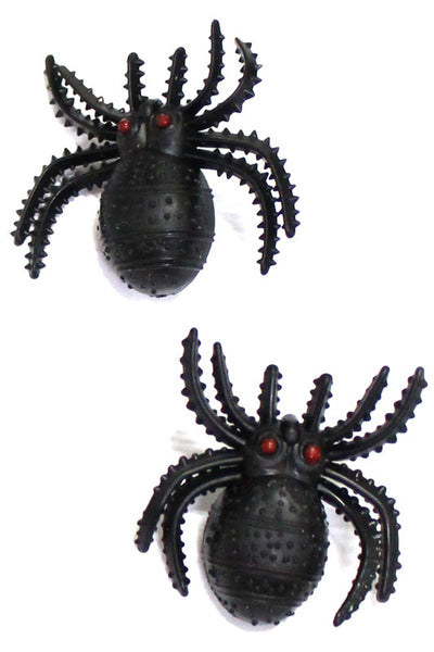 A pair of post earrings made of two black rubber spiders with red eyes