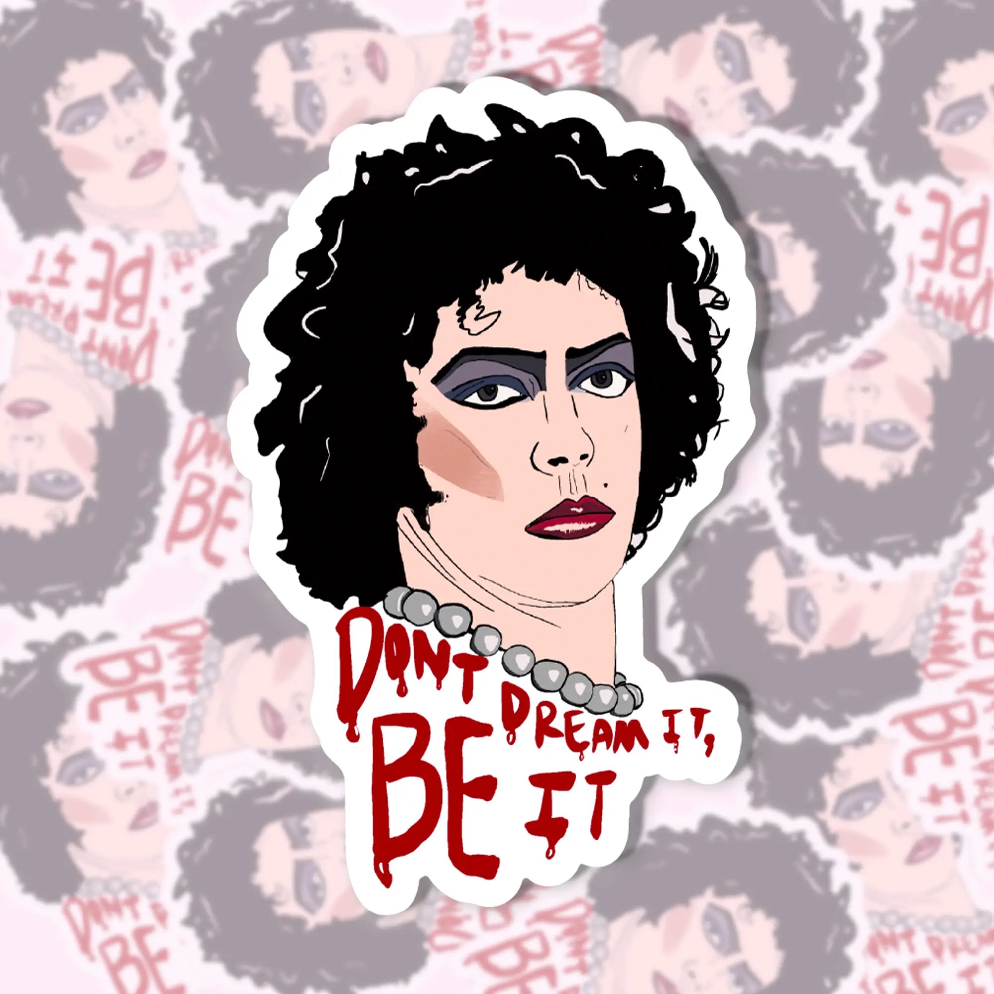A die cut sticker of Tim Curry as Dr. Frankenfurter from the Rocky Horror Picture show with the words “Don’t dream it, be if” written in red drippy font below