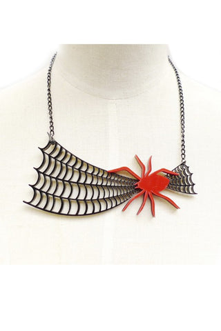 laser cut acrylic statement necklace featuring a large black spiderweb and pointy legged bright red spider