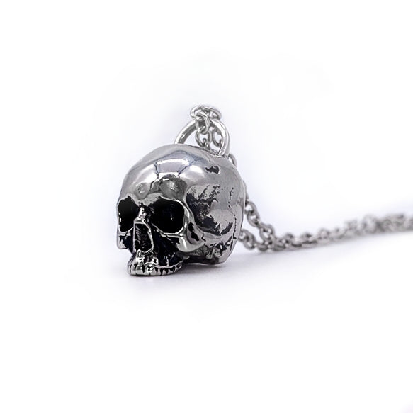 A stainless steel detailed pendant of a skull on a 20” bold link chain