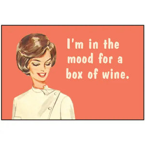 A rectangular magnet of a woman smiling in front of an orange background with the caption “I’m in the mood for a box of wine.”