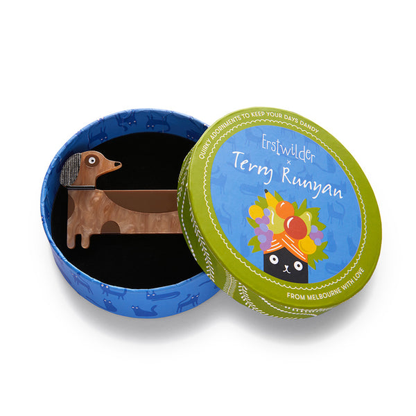 Terry Runyan Collaboration Collection "Long Dog" layered resin dachshund brooch, shown in illustrated round box packaging