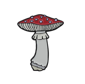 shiny black enameled pin of the classic red and white spotted amanita muscaria mushroom