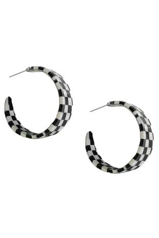 A pair of acrylic hoop earrings in a black and white checker pattern. Attaches to the ear as a post