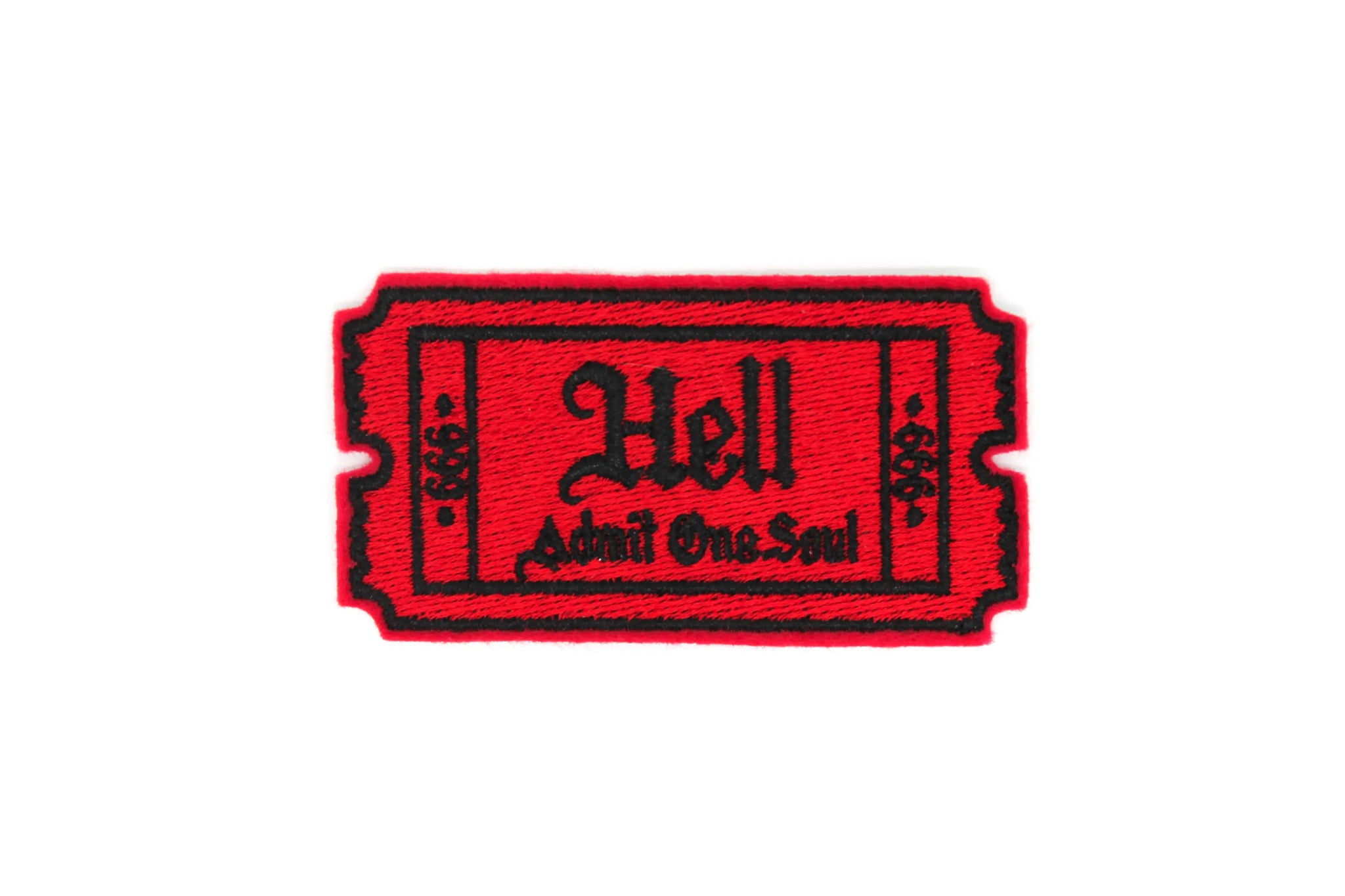 An embroidered patch in the shape of a ticket stitched in red with black writing. It says “Hell” and “Admit One Soul” below. On both sides of the ticket are the number 666