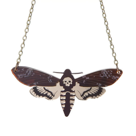A gold plated chain link necklace with a large charm of laser-cut layered acrylic in shades of amber and brown with shiny gold and matte etched detailing on the wings.