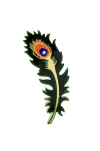 A layered acrylic brooch in the shape of a green, yellow, orange, and blue peacock feather with gold mirror detail and a silver rhinestone in the middle