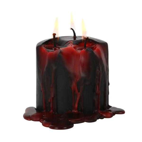 A small black pillar candle that drips bloody red when lit. Shown lit with red wax dripping down its side