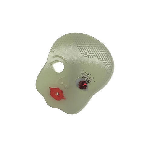 One-eyed with lashes and red jewel iris, red lipped, bald babydoll head laser cut glow-in-the-dark acrylic brooch