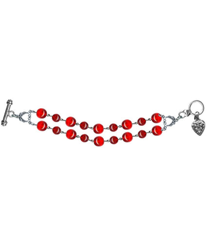 Toggle closure bracelet featuring a double row of linked round translucent red glass beads and a small silver metal ornate heart charm