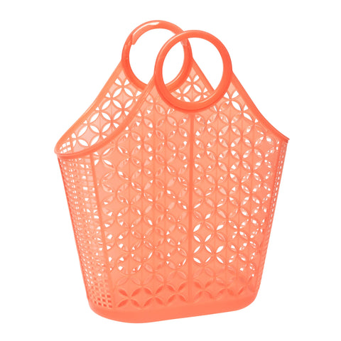 A large neon orange plastic purse with two round interlocking handles, a flat base, and a diamond and grid pattern