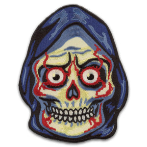 An embroidered patch of a grim reaper style character with a skull head wearing a black hood