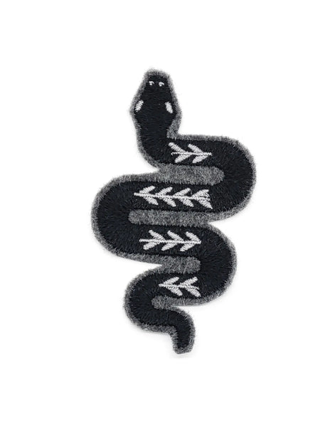 An embroidered patch of a stylized illustration of a snake in grey and black stitching. There is leaf detail on the body of the snake