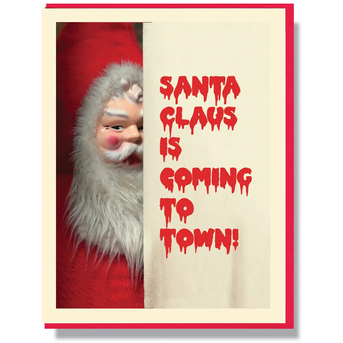 A greeting card of a scary looking Santa Claus doll and the caption “Santa Claus is Coming to Town!” in a red dripping horror movie font