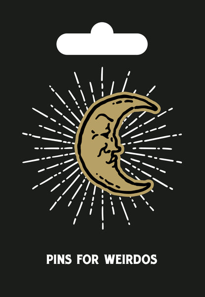 Hard enamel pin of a golden crescent moon with a pensive look on its illustrated face