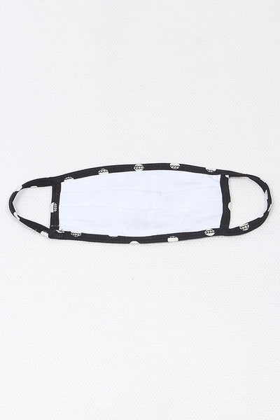 black with creamy white polka dot print poly/cotton blend knit face mask with self ear loops, showing solid white lining