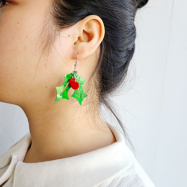 laser-cut acrylic green holly leaf pair with red berry charms dangle earring, shown on model