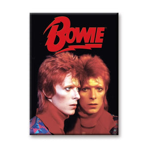 A rectangular magnet of David Bowie in his 1972-1973 Ziggy Stardust persona with the lightning bolt Bowie logo in red on a black background. He is standing next to a mirror and staring in it