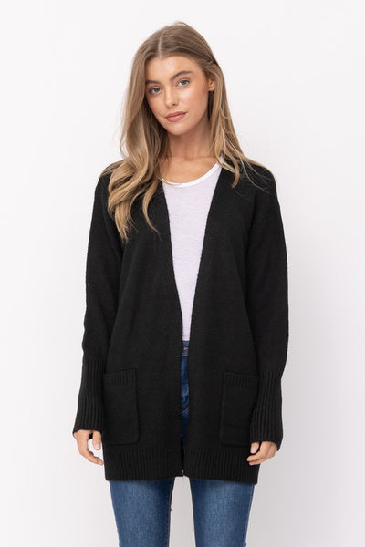 A black open front cardigan with patch pockets and ribbed cuffs & bottom hem. Shown on model 