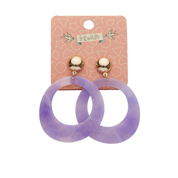 pair Essentials Collection light purple ripple texture 100% Acrylic resin circle suspended from a shiny gold metal dome post drop earrings, shown on illustrated header packaging