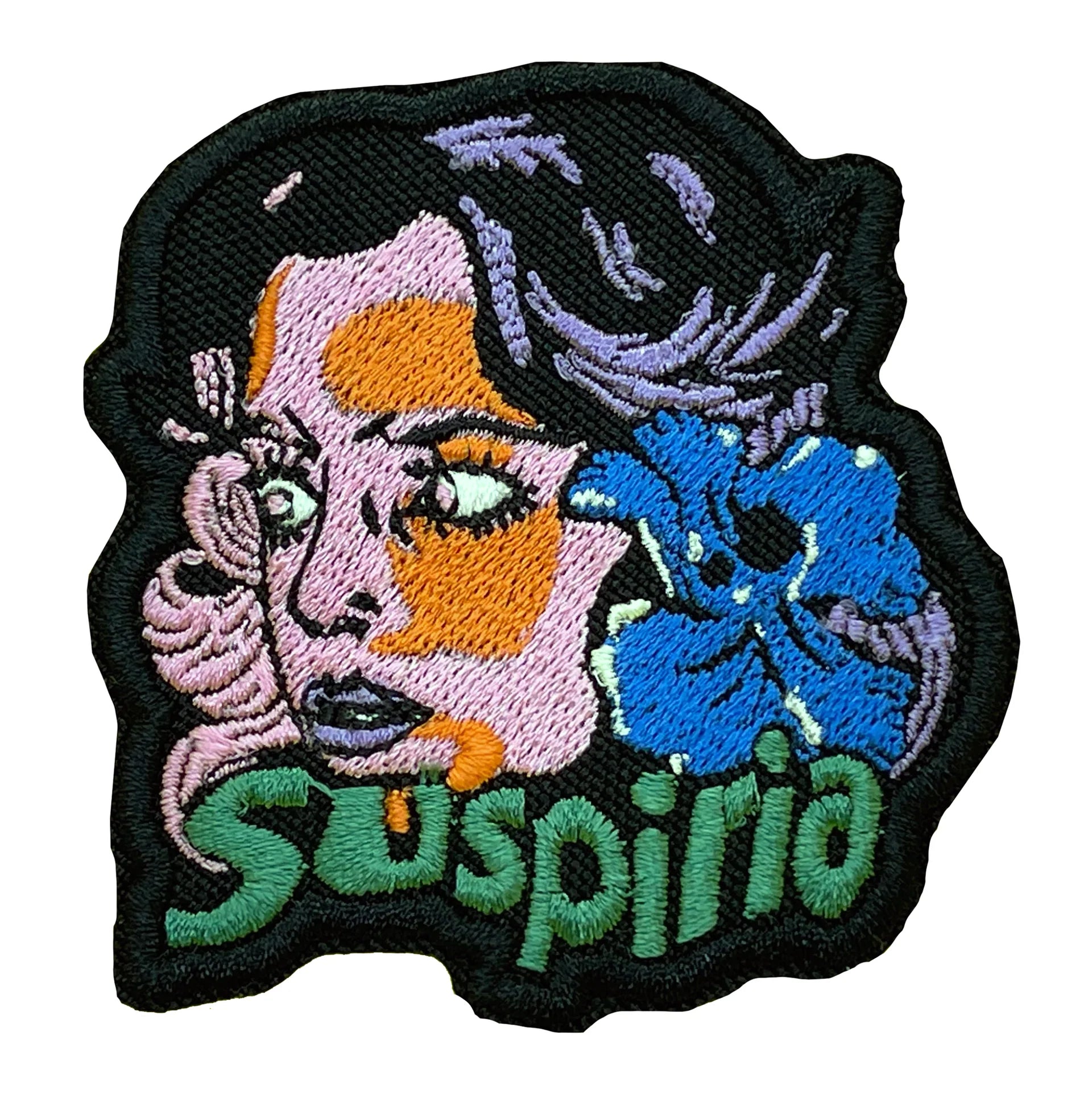 An embroidered patch of the lead character Suzy with the infamous blue Iris in her hair, from Dario Argento's 1977 Italian horror film Suspiria.