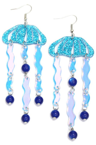 Dangle earrings of blue laser cut acrylic in the shape of a jellyfish with dangling tentacles and blue beads 