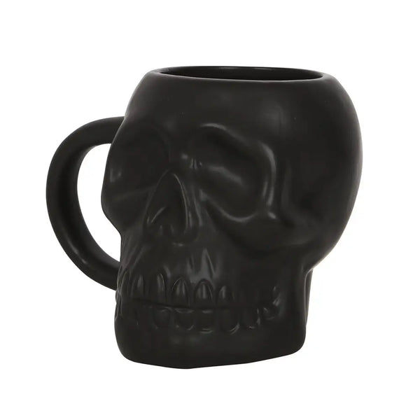A black satin finish ceramic mug in the detailed shape of a skull. Seen at a 3/4 view to show detail 