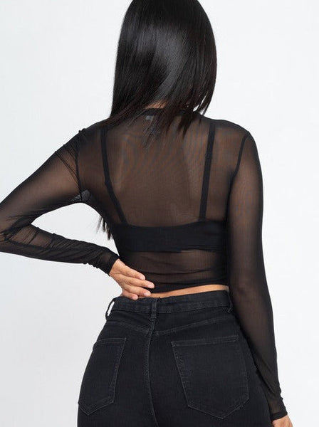 A long sleeved cropped black mesh top with round neck. Worn on model shown from behind