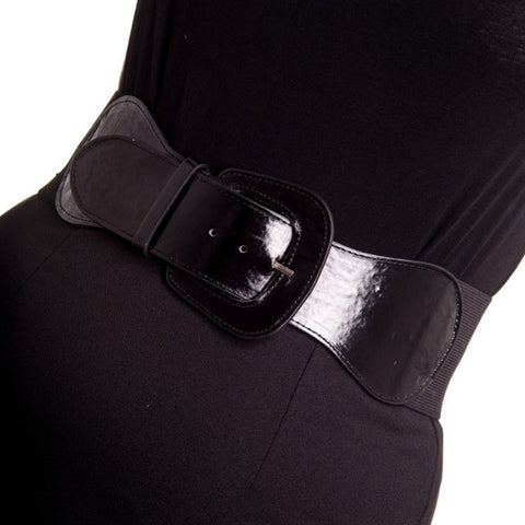 shiny black patent 3 1/4” wide adjustable elastic belt with angled self buckle. Shown on a model’s waist