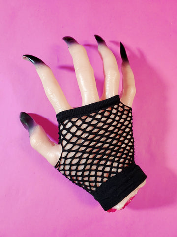 Wrist-length black fingerless fishnet glove, shown on halloween prop hand