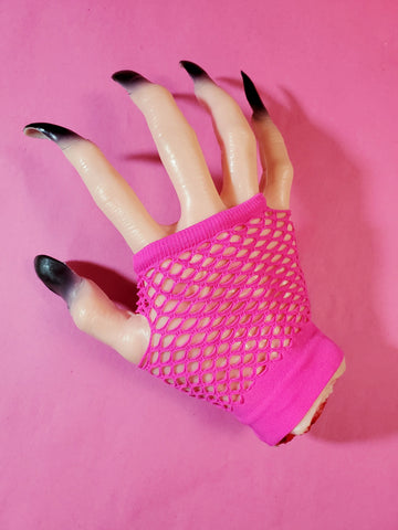 Wrist-length bright hot pink fingerless fishnet glove, shown on halloween prop hand