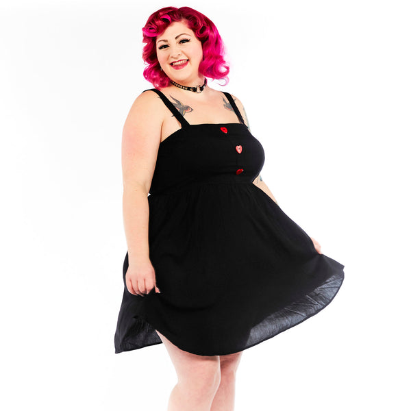 black mini sundress with three red heart-shaped button