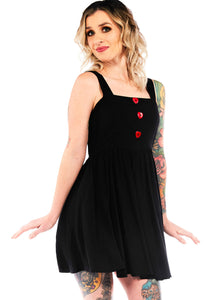 black mini sundress with three red heart-shaped button on bodeice, shown on model