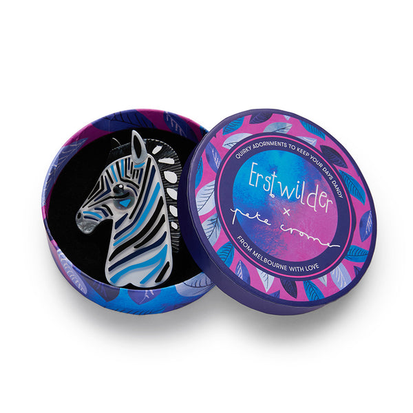 artist Pete Cromer x Erstwilder Wildlife Collaboration Collection "The Zealous Zebra" black, white, and blue layered resin brooch, shown in illustrated round box packaging