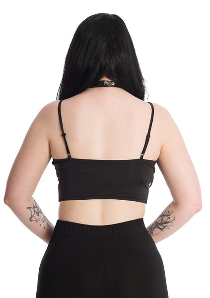 A model wearing a black bustier style crop top with a sweetheart neckline with batwing-style scalloped detail at the top of the bodice, 4 rows of lace-up eyelets with silver metal hardware, and adjustable spaghetti straps. Shown from the back