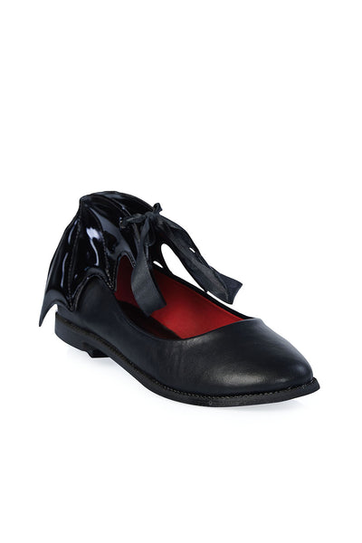 A pair of black faux-leather flat shoes with a black ribbon tie at the front of each shoe and a black patent quilted batwing around each ankle. Shown from the front 