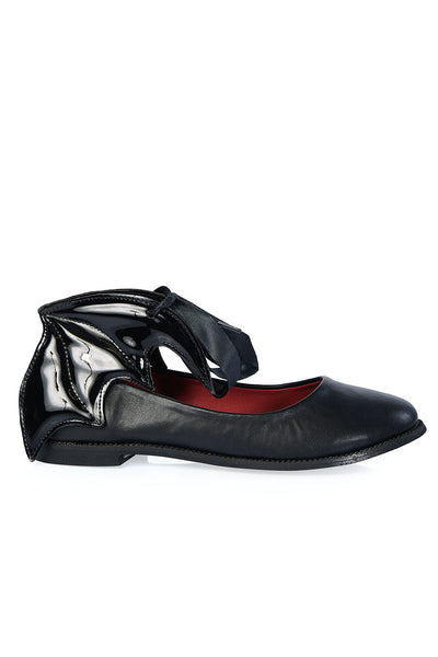 A pair of black faux-leather flat shoes with a black ribbon tie at the front of each shoe and a black patent quilted batwing around each ankle. Shown from the side