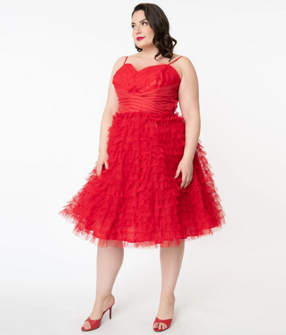 50s style party dress featuring a fitted wrapped red satin band boned bodice with sweetheart neckline and adjustable spaghetti straps, and rows and rows of fluffy red tulle on the bust and full swingy skirt, shown on model