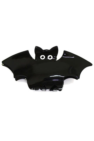 shiny plastic claw style hair clip in the shape of a black bat with big white and black eyes