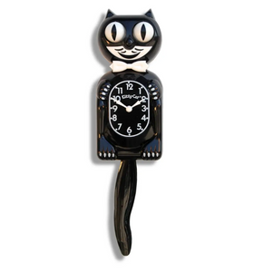 black & white Kitty-Cat wall mount clock features a mischievous grin, and big round eyes that swivel side-to-side in time with its pendulum tail 