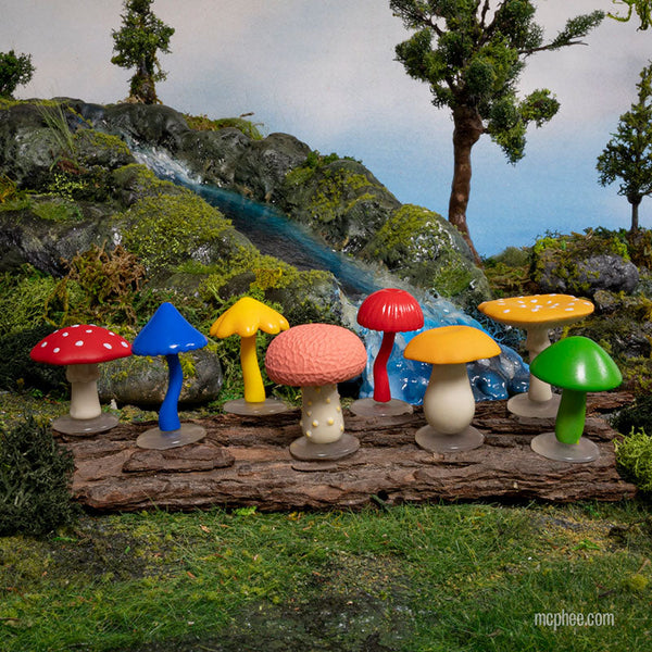 colorful collection of eight different soft vinyl mini mushrooms, pictured on display in outdoor scene